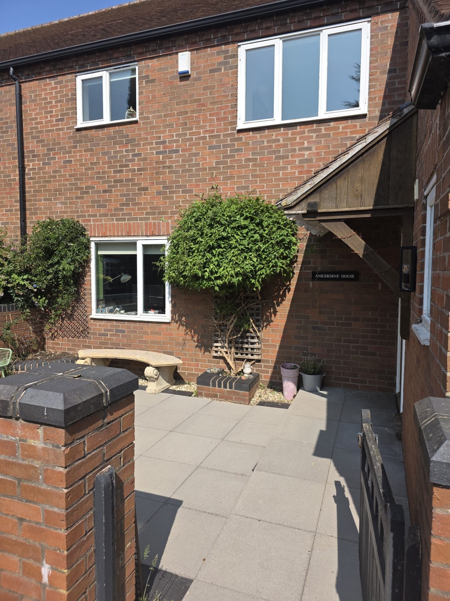 Commercial grounds maintenance Worcester – tidy front garden of brick home.