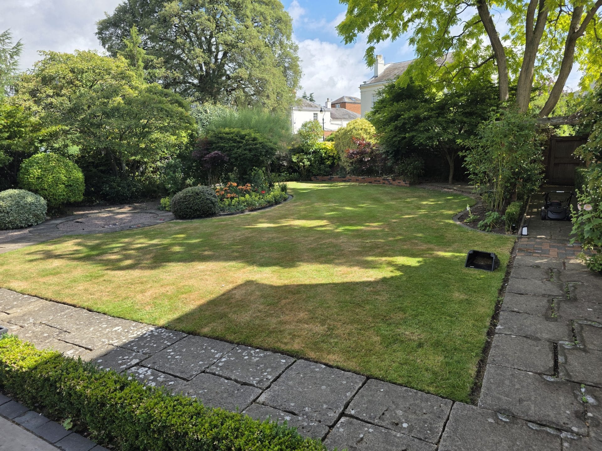 Commercial grounds maintenance Worcester – landscaped tree area with stones.