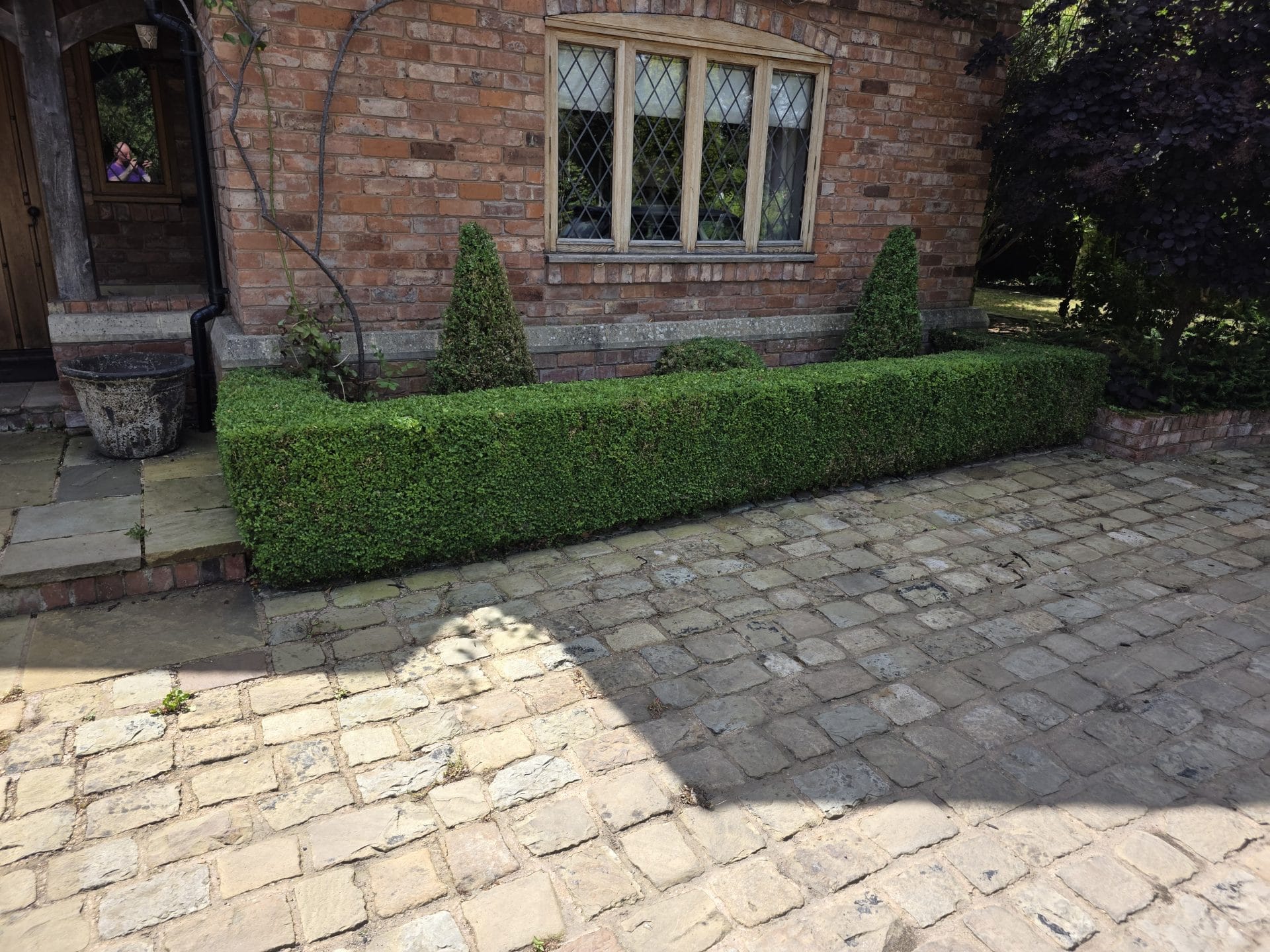 Commercial grounds maintenance Worcester – trimmed hedges along brick house.