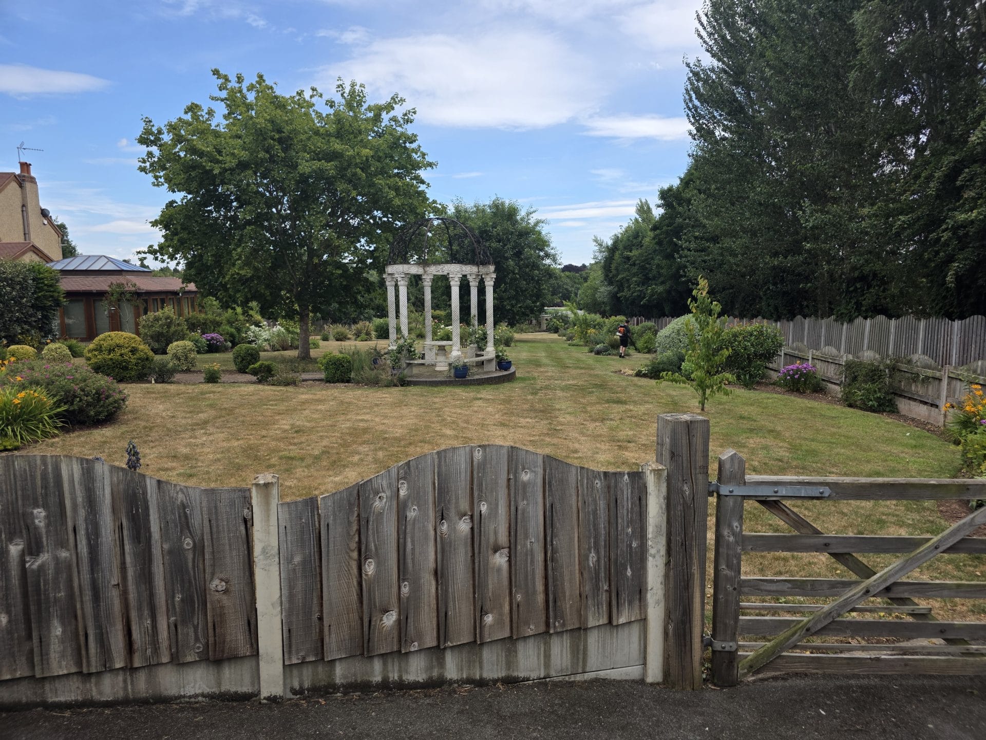 Garden maintenance Kidderminster – country-style garden with wooden gate.