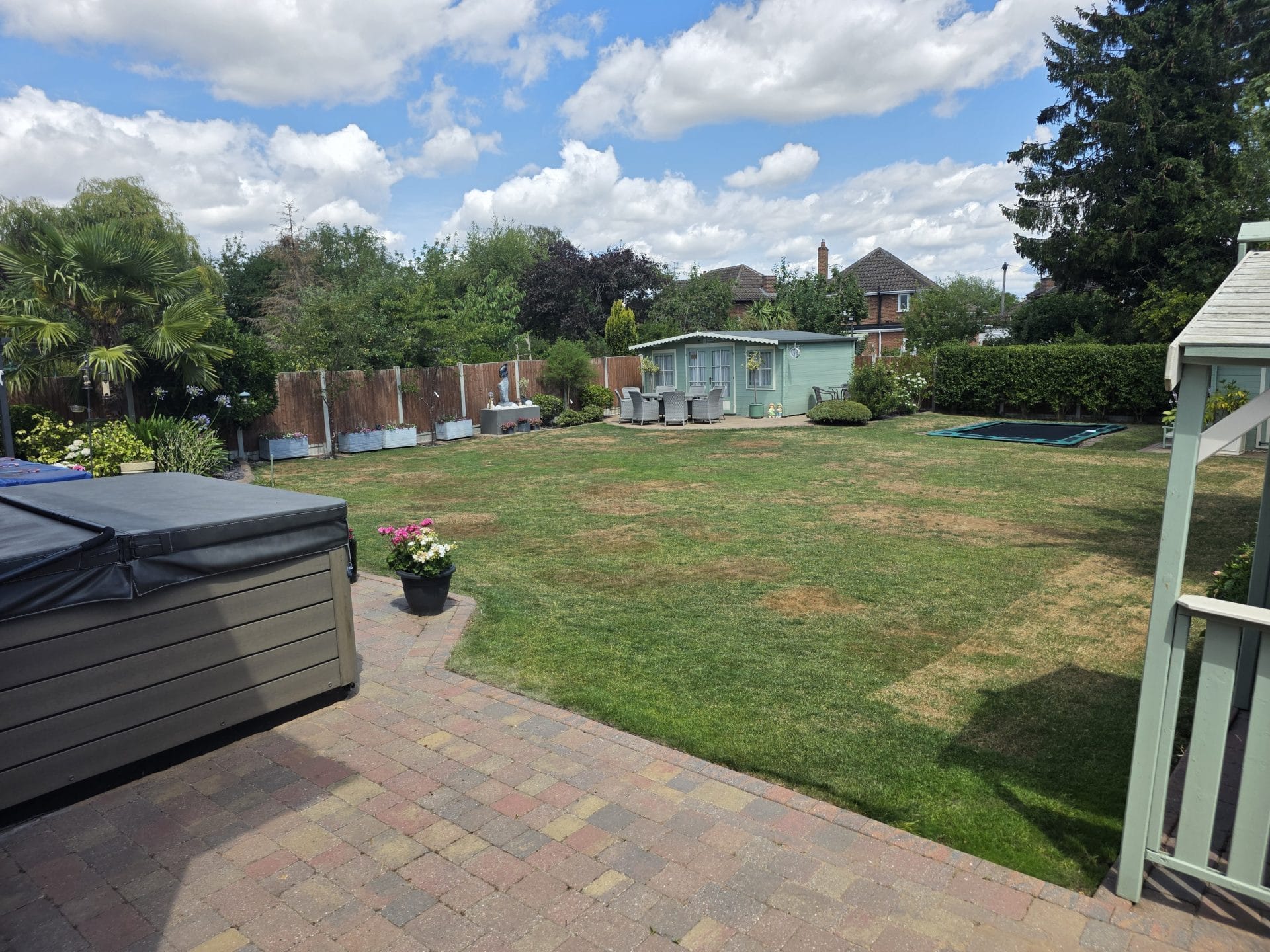 Garden maintenance Worcester with neatly cut lawn and patio area.